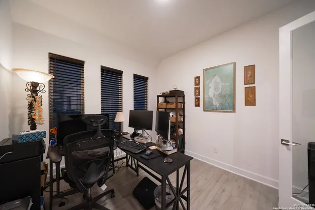 a living room with furniture wooden floor and ceiling fan