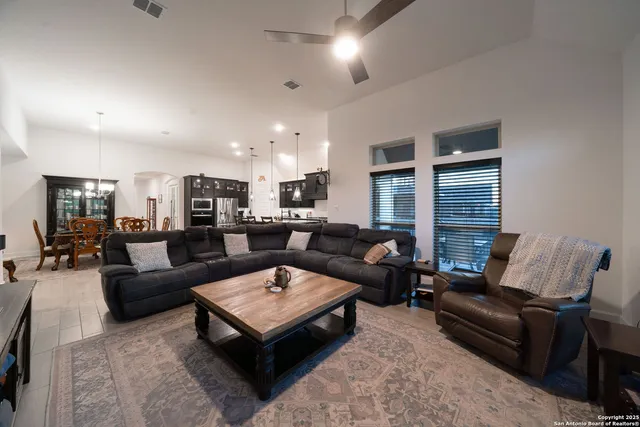 a dining room with furniture and view kitchen
