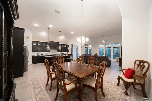 a living room with furniture a flat screen tv and kitchen view
