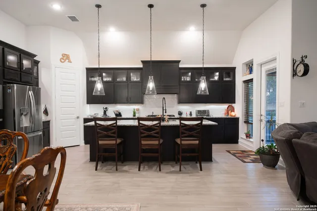a kitchen with granite countertop a sink dishwasher stove and cabinets