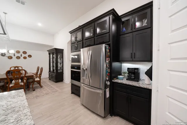 a large kitchen with kitchen island a sink counter space and stainless steel appliances