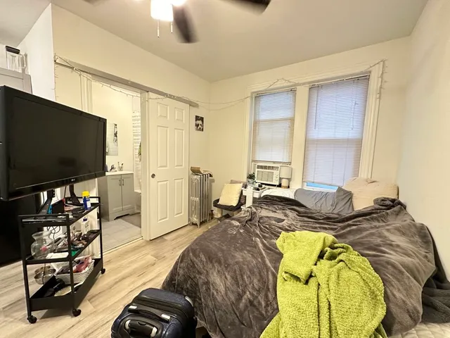 a bed room with furniture and a flat screen tv