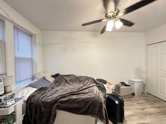 a bed sitting in a bedroom next to a window