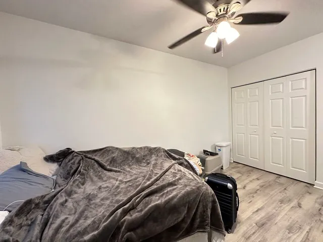 a bedroom with a bed and a chandelier