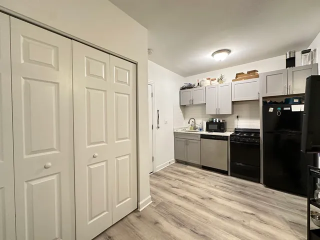 a kitchen with stainless steel appliances granite countertop a refrigerator and a stove top oven
