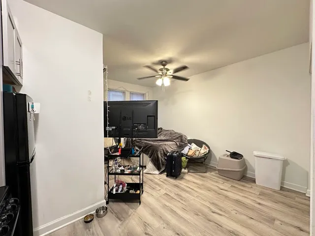 a bedroom with a bed and a flat tv screen on the dresser