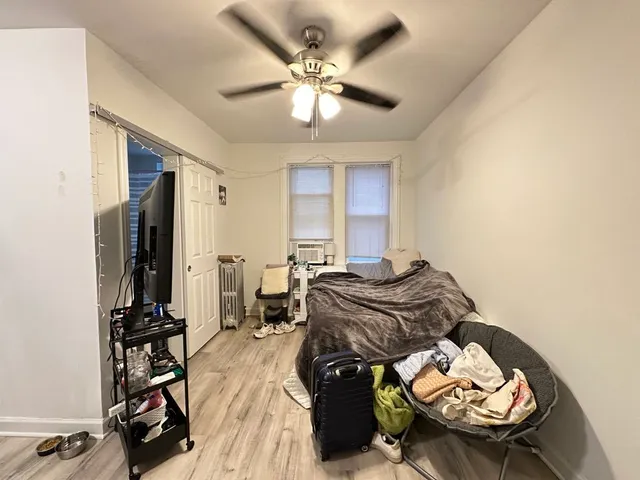 a bedroom with furniture and a mirror