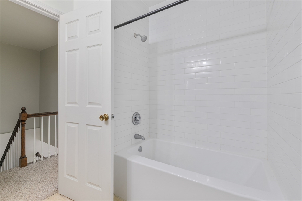 128 Warren Street, Unit 12 Lowell, MA 01852 - Photo 15 of 24 a bathroom with a bathtub