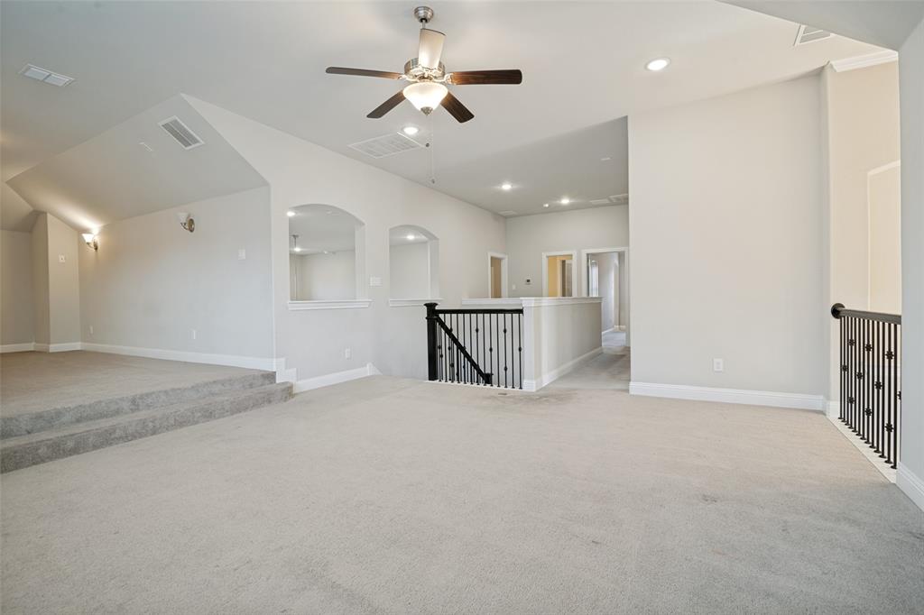 2802 Merlot Circle Rowlett, TX 75088 - Photo 26 of 40 an empty room with a kitchen and a ceiling fan