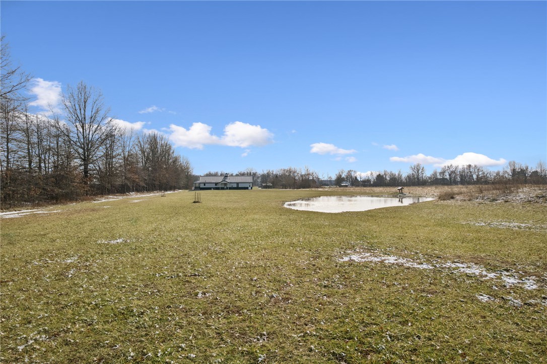 1602 Westboro Road Blanchester, OH 45107 - Photo 40 of 81 Expansive landscape features a serene pond, offering tranquility and natural beauty.