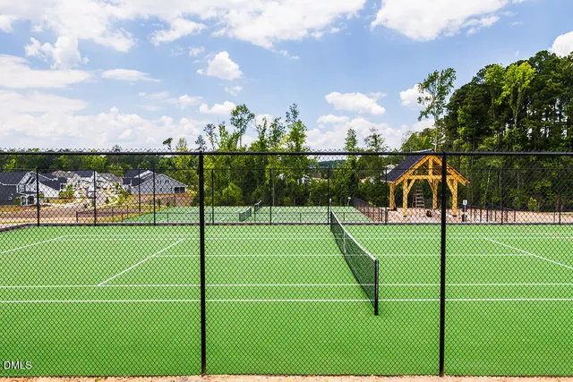 a view of a house with swimming pool and sitting area