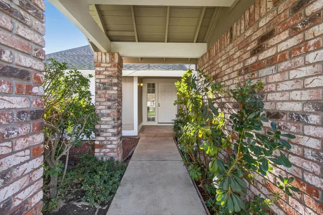 a view of entryway with wooden floor and a front door