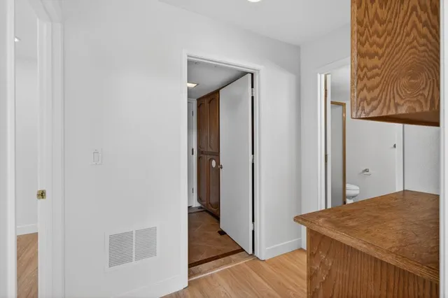 a bathroom with a granite countertop sink a toilet and a mirror