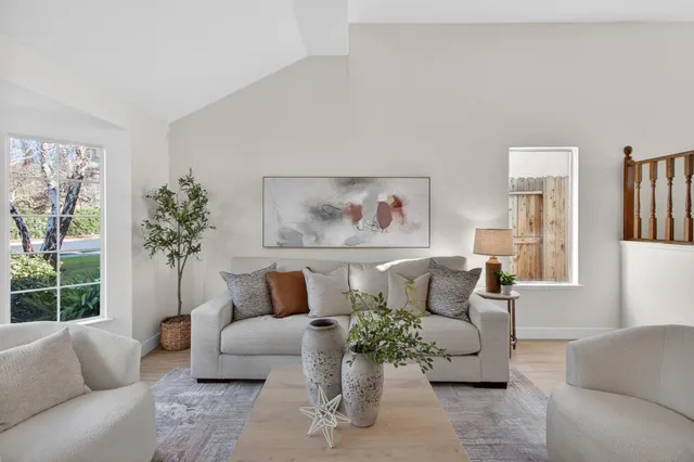 a kitchen with stainless steel appliances granite countertop a refrigerator a sink dishwasher and wooden cabinets with wooden floor