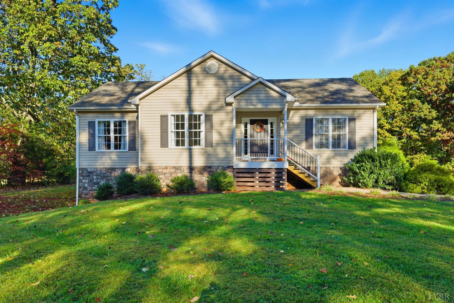 a front view of house with yard and green space