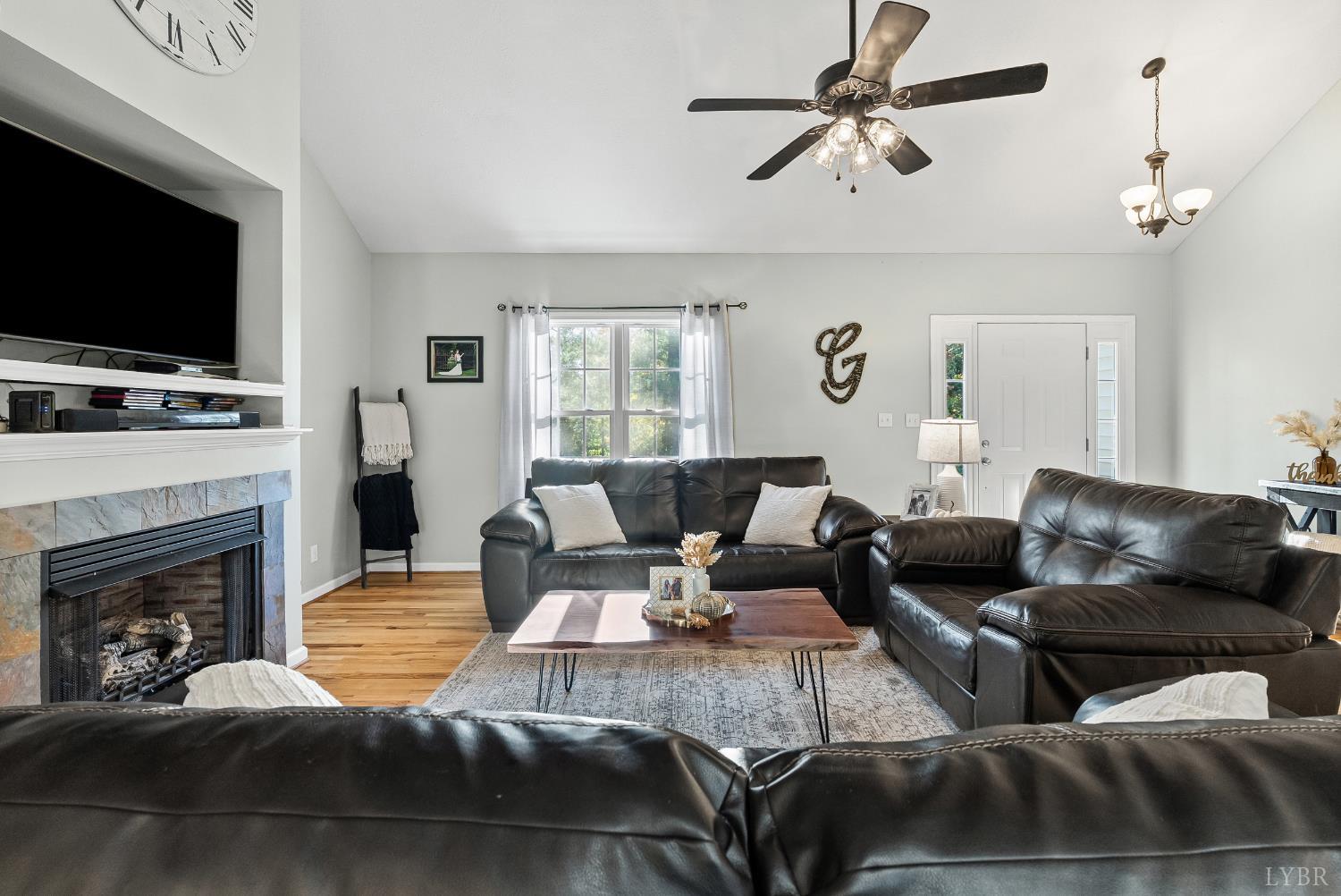 2739 Chilton Road Appomattox, VA 24522 - Photo 5 of 30 a living room with furniture a fireplace and a flat screen tv