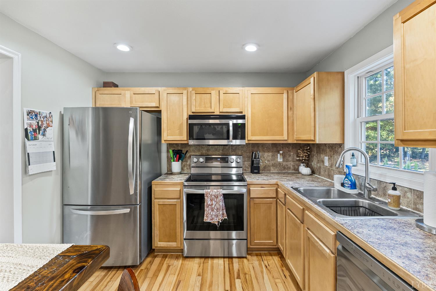 2739 Chilton Road Appomattox, VA 24522 - Photo 9 of 30 a kitchen with a refrigerator a sink and wooden cabinets