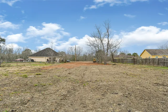 a view of large yard with large trees