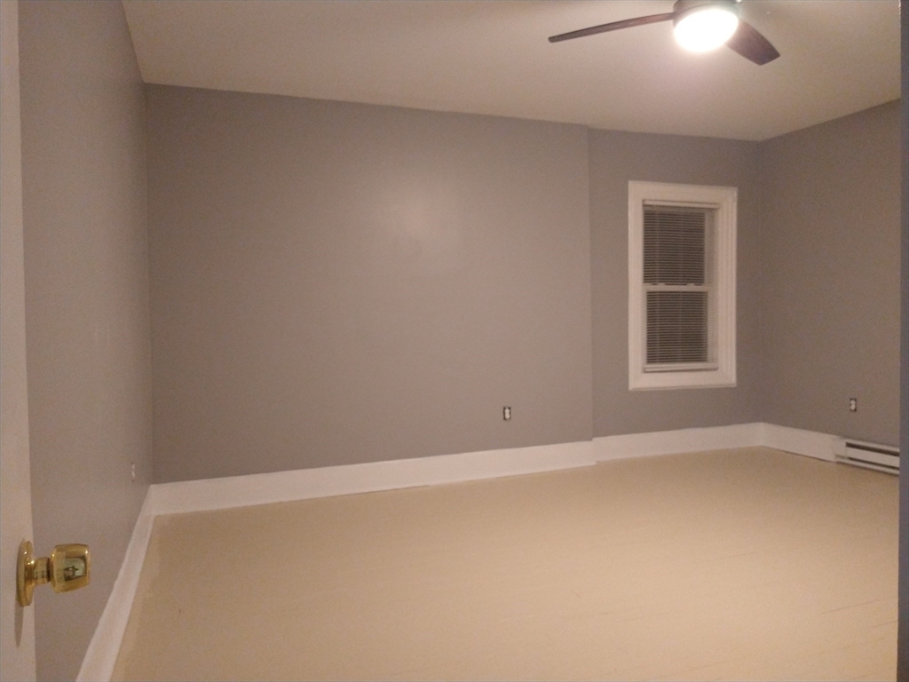 6 Brandon Road, Unit 2 Dudley, MA 01571 - Photo 2 of 13 an empty room with a window