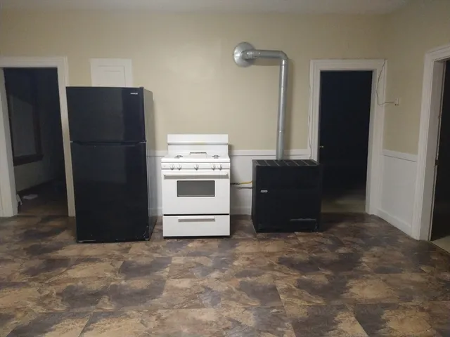a kitchen with a refrigerator and a stove