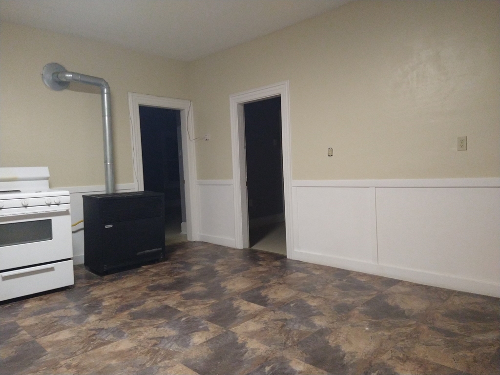 6 Brandon Road, Unit 2 Dudley, MA 01571 - Photo 10 of 13 a view of an empty room with a kitchen