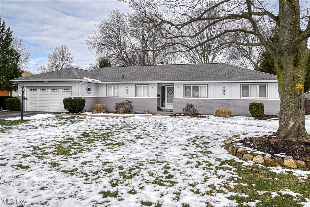 1989 Larchmont Road Akron, OH 44313 - Photo 2 of 38 Ranch-style home featuring driveway, entry steps, a garage, and brick siding