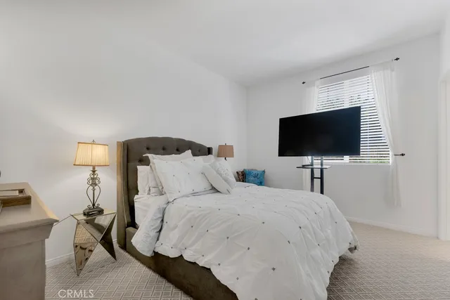 a hotel room with a bed and a flat screen tv