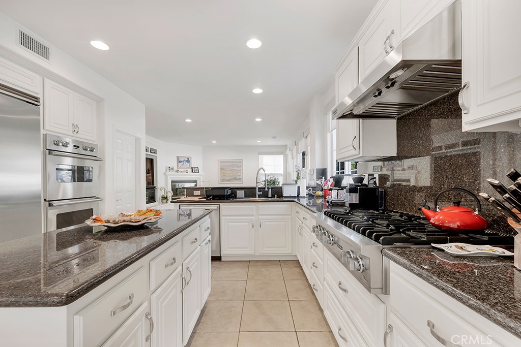 3049 Heavenly Ridge Street Thousand Oaks, CA 91362 - Photo 16 of 50 a kitchen with stainless steel appliances granite countertop a sink a stove and cabinets