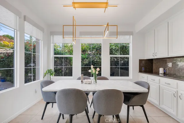 a kitchen with a table chairs and wooden floor