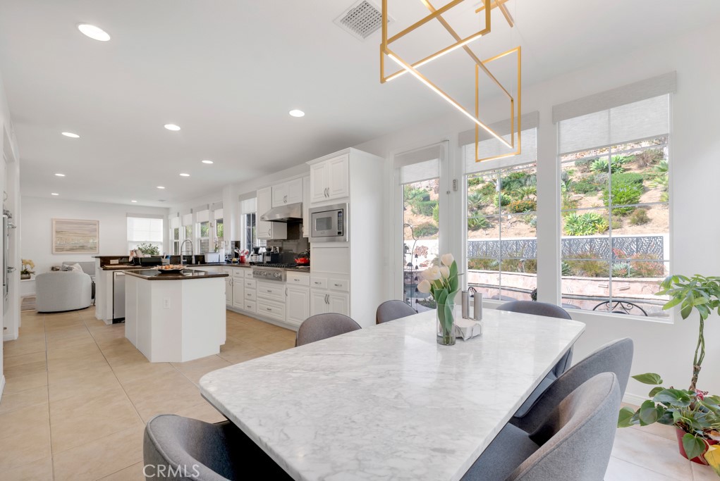 3049 Heavenly Ridge Street Thousand Oaks, CA 91362 - Photo 19 of 50 a kitchen with stainless steel appliances kitchen island granite top and stainless steel appliances