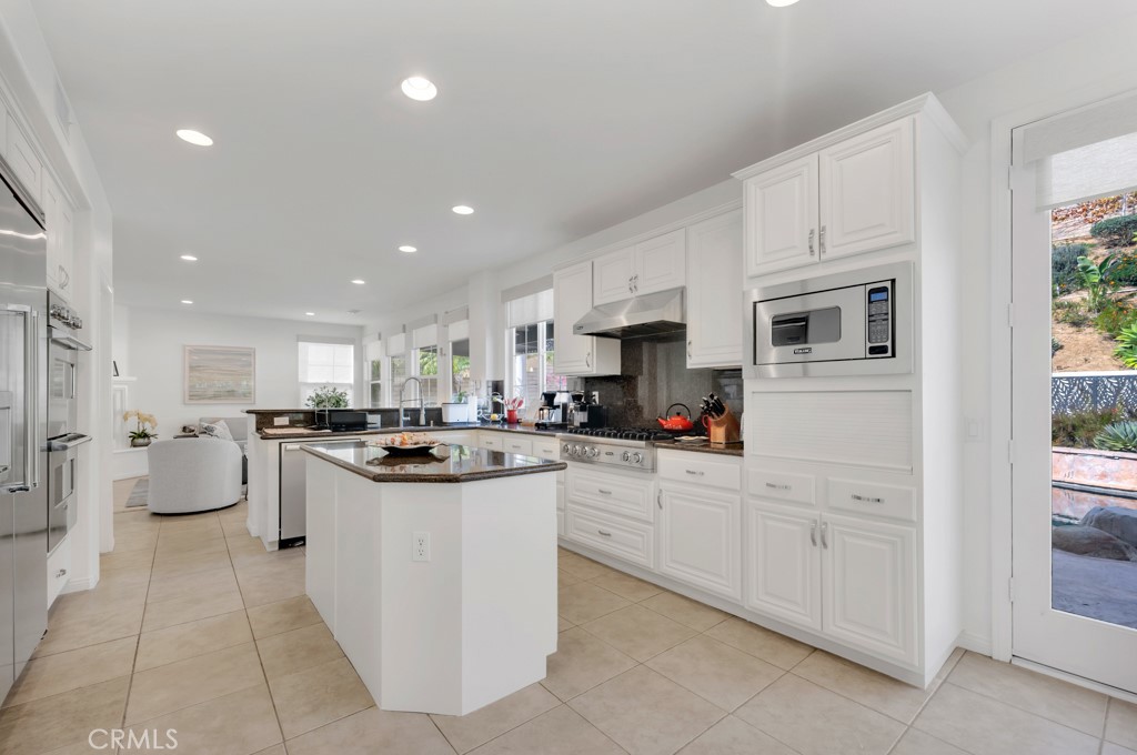 3049 Heavenly Ridge Street Thousand Oaks, CA 91362 - Photo 20 of 50 a kitchen with white cabinets and white appliances