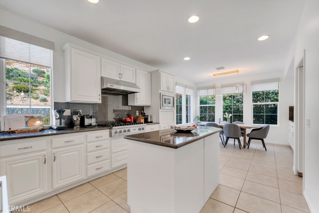 3049 Heavenly Ridge Street Thousand Oaks, CA 91362 - Photo 22 of 50 a kitchen with granite countertop a sink and white cabinets