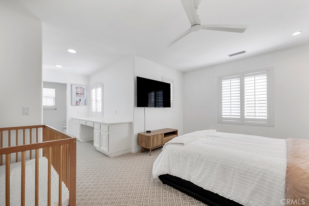 3049 Heavenly Ridge Street Thousand Oaks, CA 91362 - Photo 39 of 50 a bedroom with a bed window and a flat screen tv