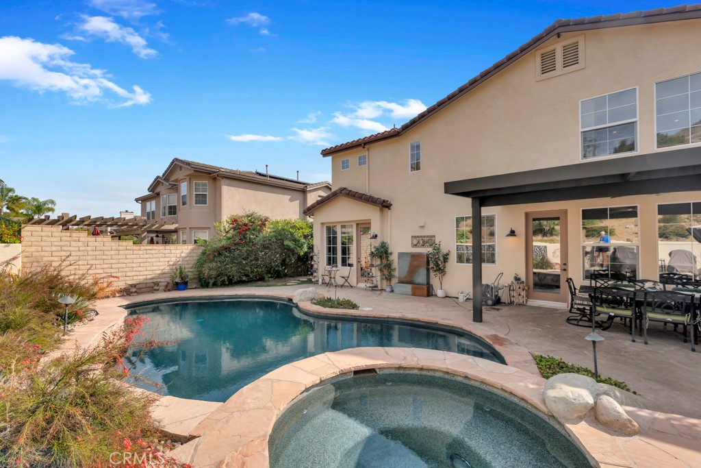 3049 Heavenly Ridge Street Thousand Oaks, CA 91362 - Photo 48 of 50 a swimming pool with outdoor seating and yard