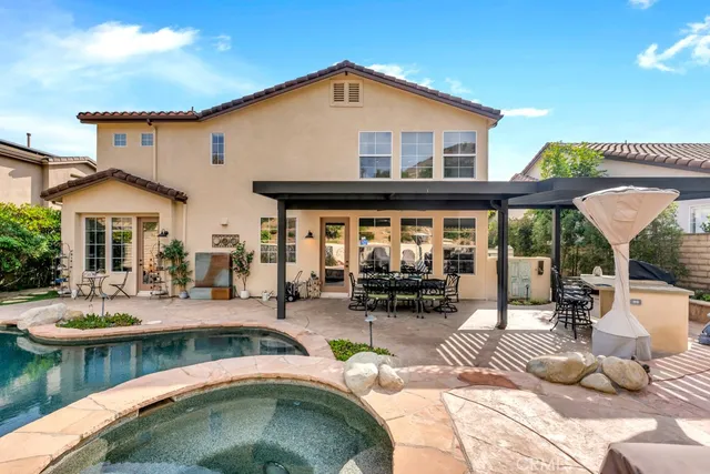 a view of a house with swimming pool and sitting area
