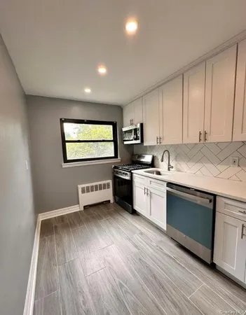 a kitchen with wooden floors and white appliances