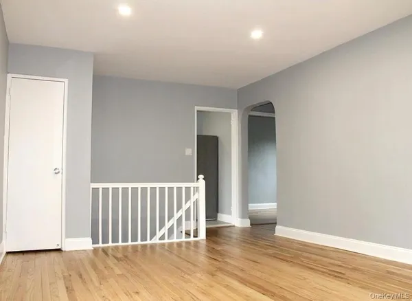 a view of a room with wooden floor