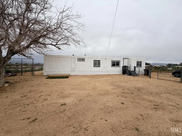 a view of a house with snow on the road