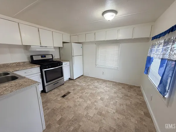 a view of a kitchen with electric appliances