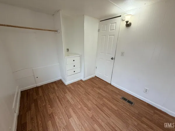 a view of a room with wooden floor