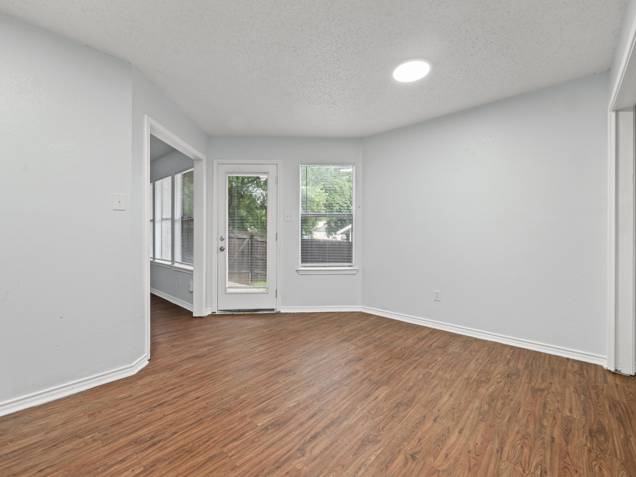 1816 Rawhide Loop, Unit 1822 Round Rock, TX 78681 - Photo 4 of 17 Unfurnished room featuring wood finished floors and a textured ceiling