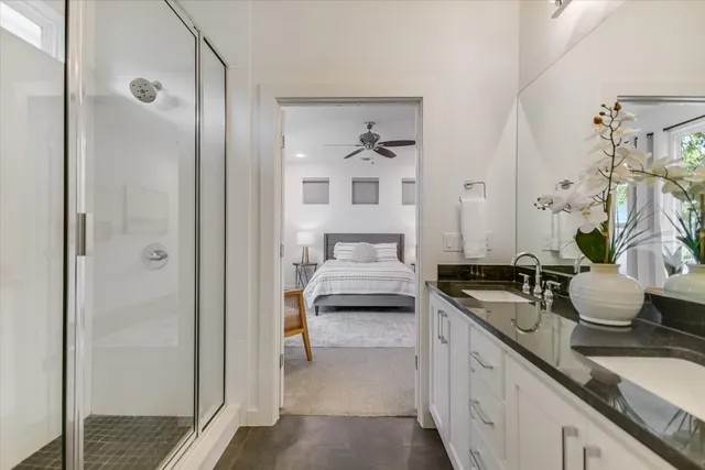 a bathroom with a granite countertop sink and a mirror