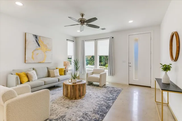 a living room with furniture and a large window