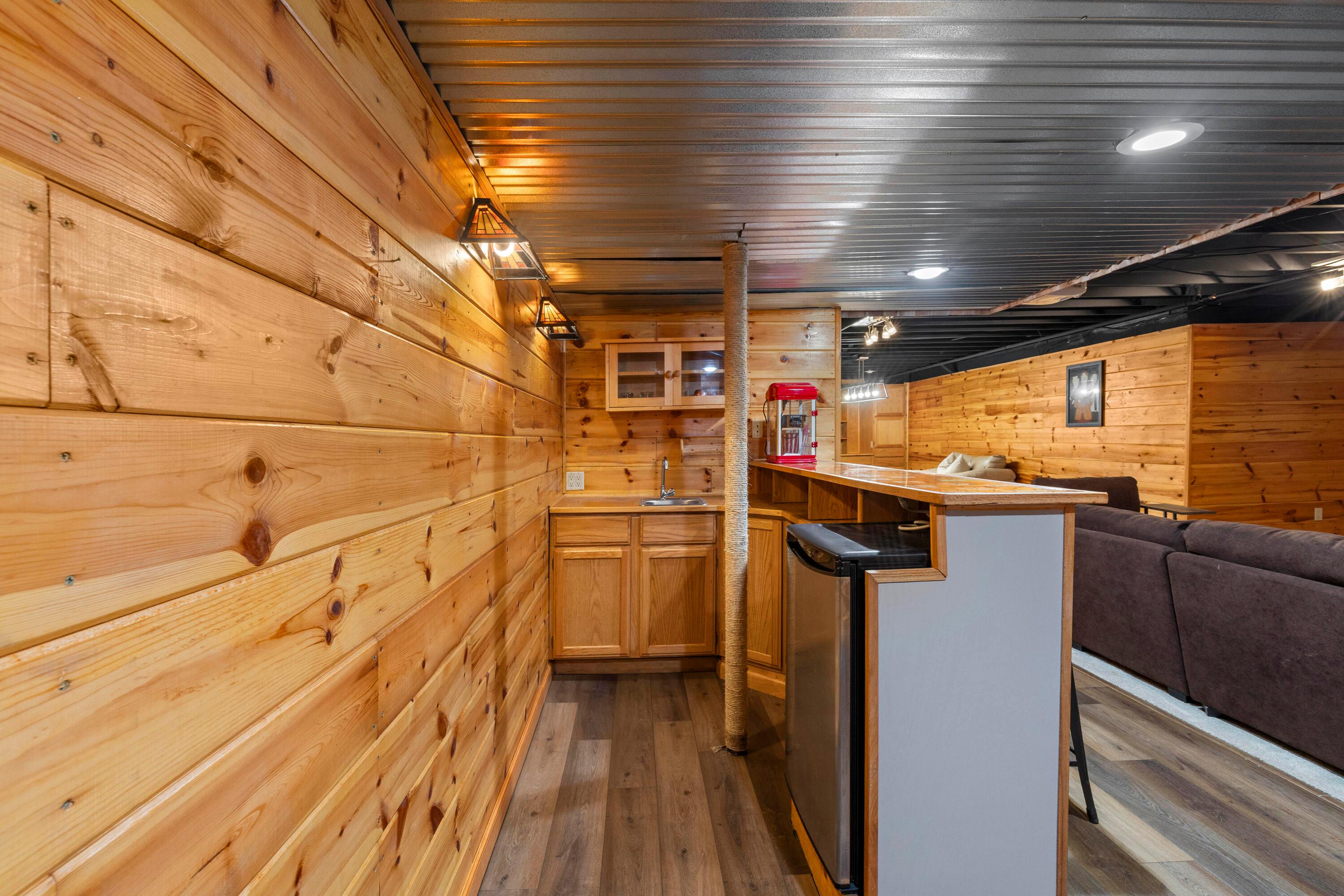 1515 Dale Ford Road Delaware, OH 43015 - Photo 57 of 74 • New luxury vinyl plank flooring ~ 2025 • Wood paneled walls • Wall mounted light • Bar ledge • Single bowl stainless steel sink (not connected) • Danby® refrigerator remians