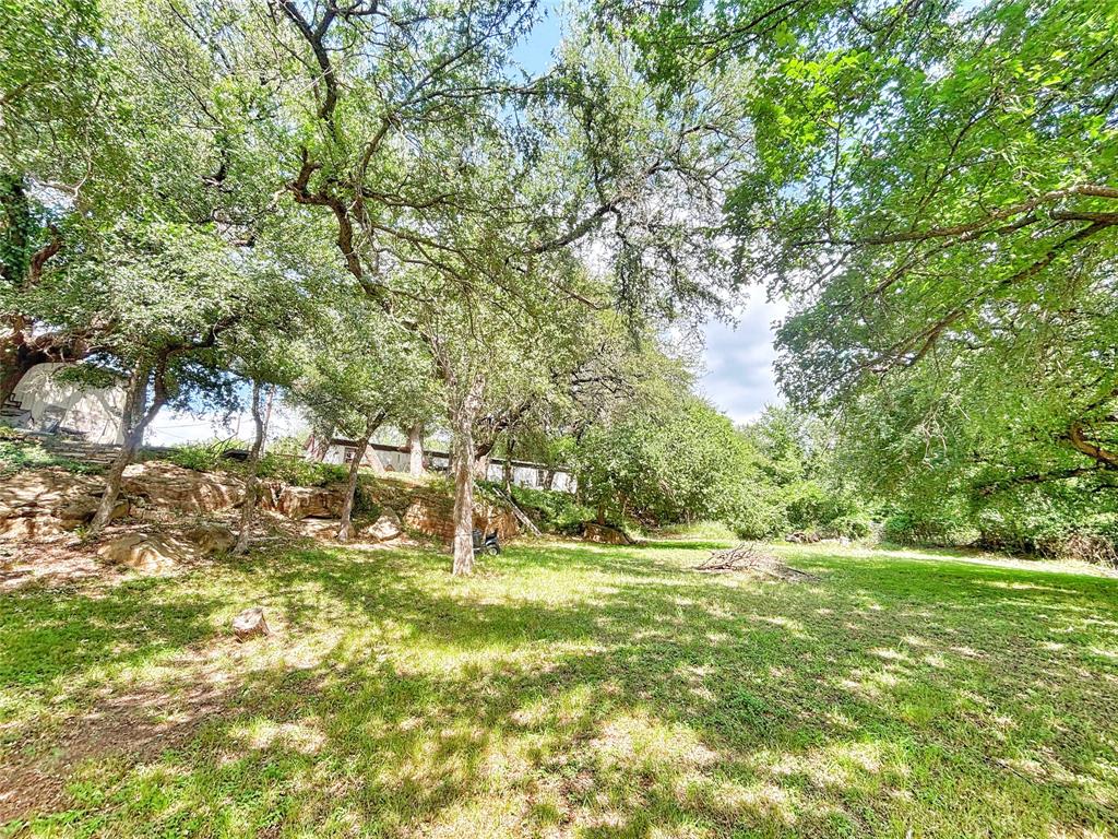 101 Riverview Road Millsap, TX 76066 - Photo 11 of 26 a backyard of a house with a yard and outdoor seating