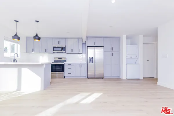 a view of a kitchen with a sink and cabinets