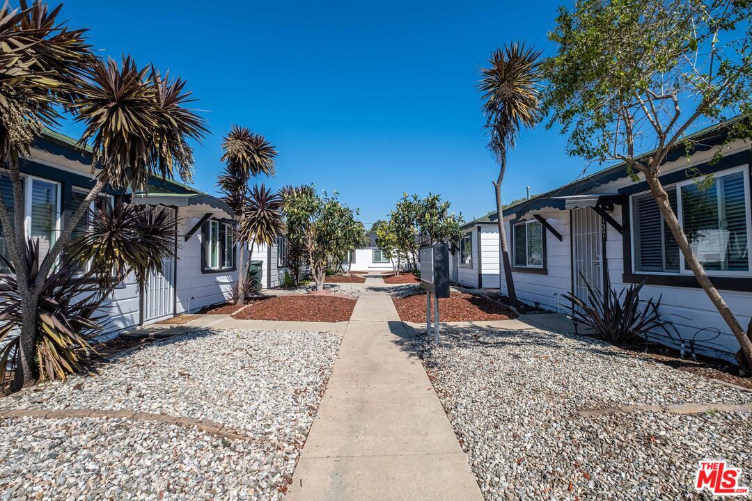 1737 252nd Street Lomita, CA 90717 - Photo 7 of 29 a wooden bench sitting in front of a house