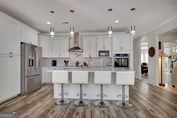 a large kitchen with a table and chairs in it
