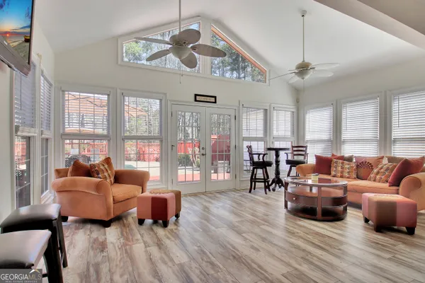 a living room with furniture and wooden floor