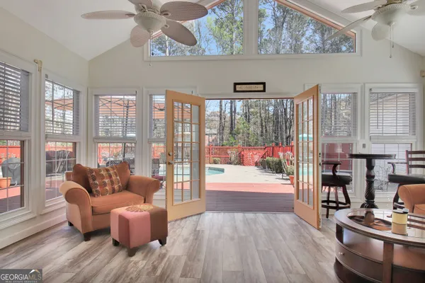 a living room with furniture and a floor to ceiling window